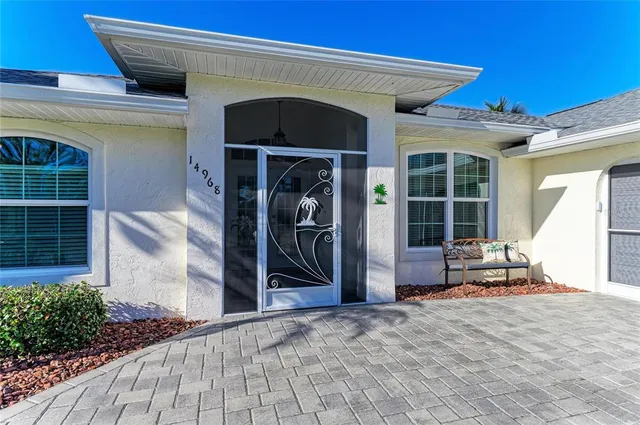 a living room with furniture a wooden floor and next to a window