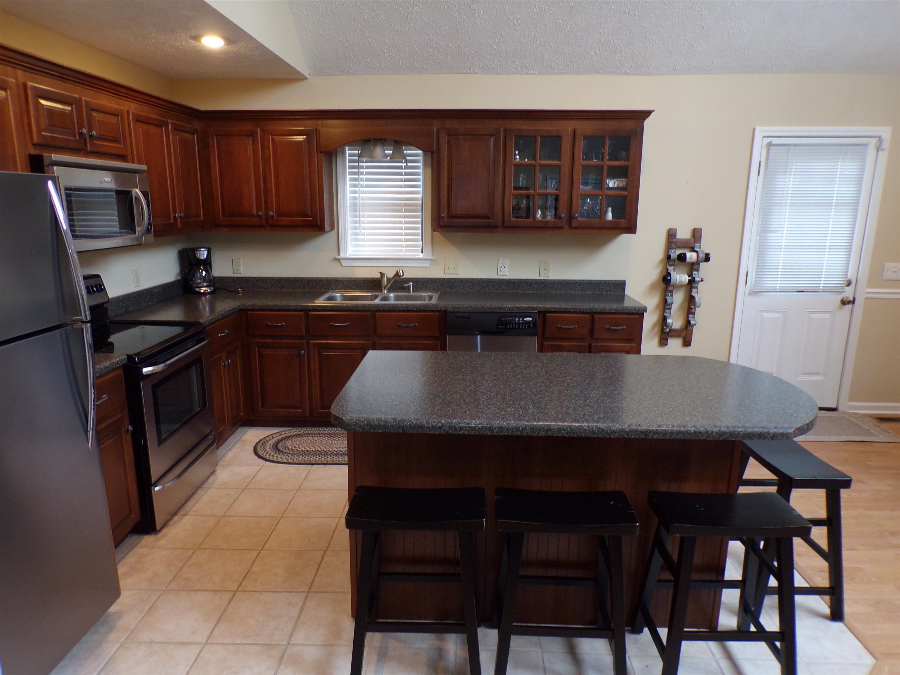 265 Missabbey Lane Counce, TN 38326 - Photo 6 of 21 a kitchen with a table chairs microwave and refrigerator