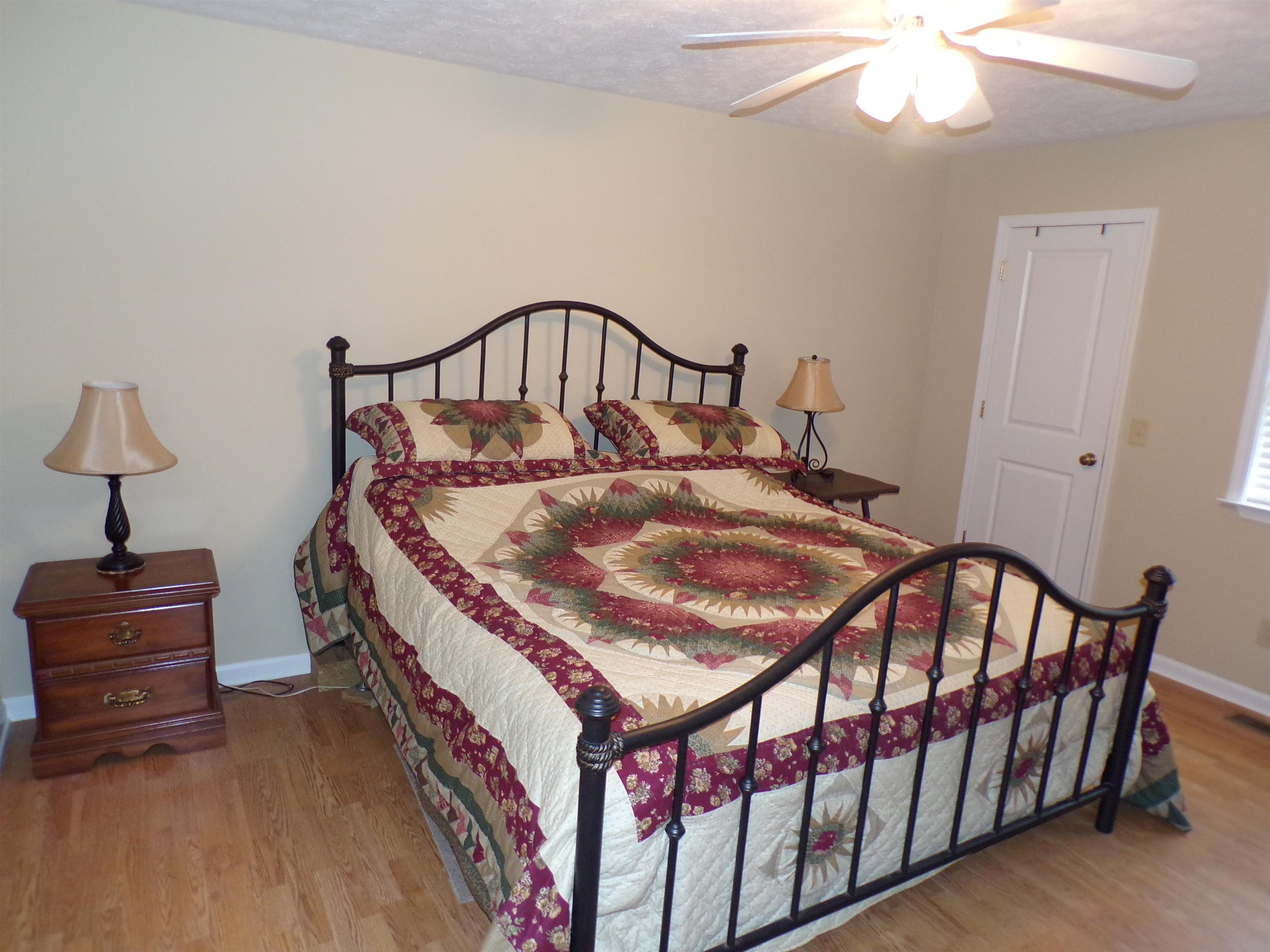 265 Missabbey Lane Counce, TN 38326 - Photo 9 of 21 a bedroom with a bed and a chandelier