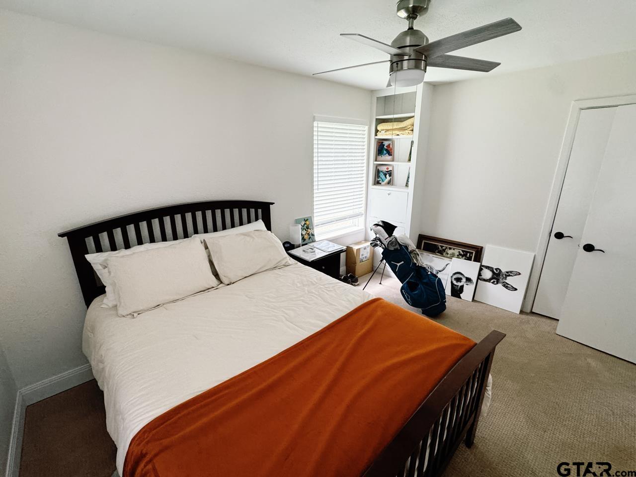 2411 Rodge Drive Tyler, TX 75701 - Photo 18 of 42 a bed sitting in a bedroom next to a window