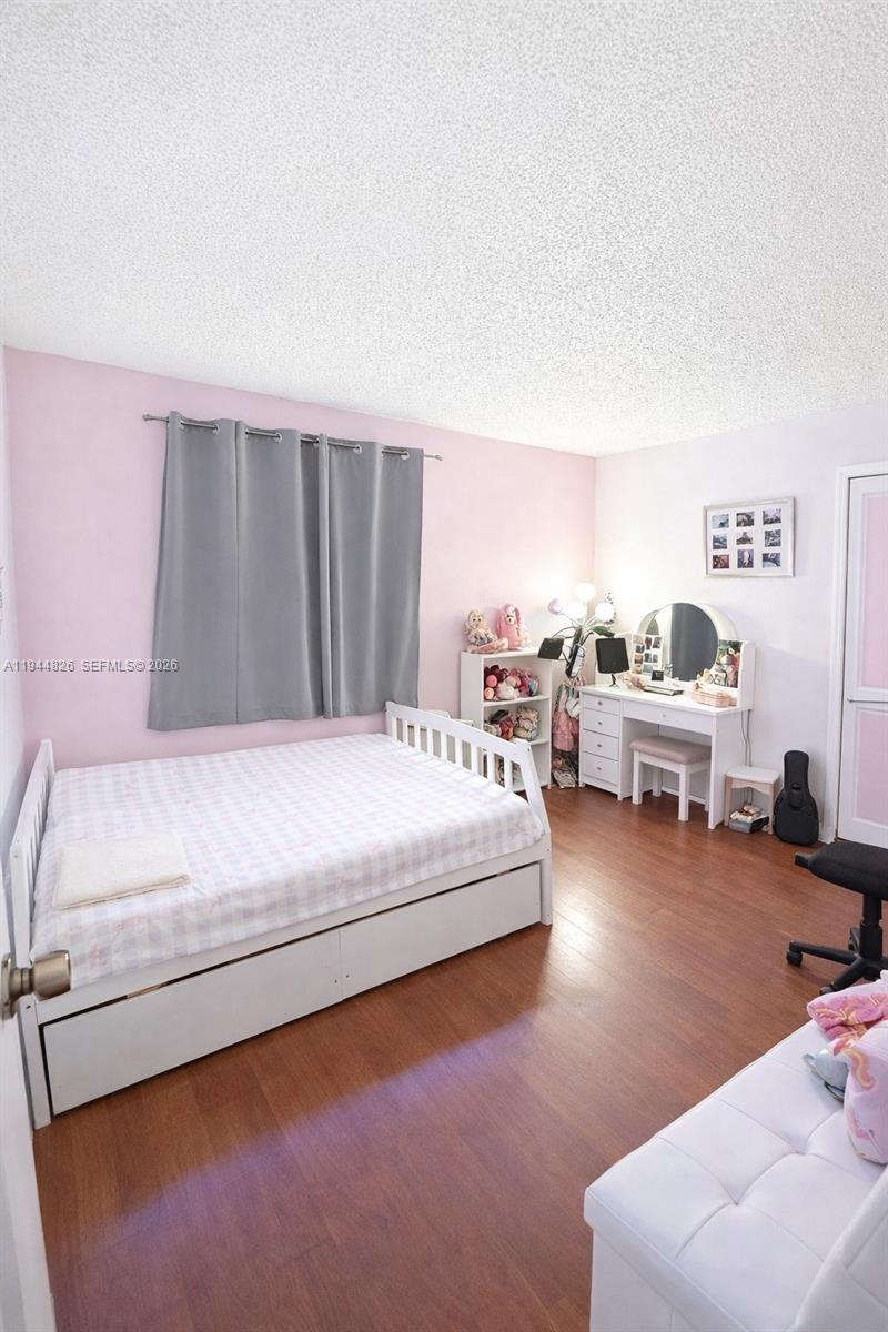 8460 Southwest 154th Cir Court, Unit 121 Miami, FL 33193 - Photo 3 of 9 a bedroom with furniture and a large window