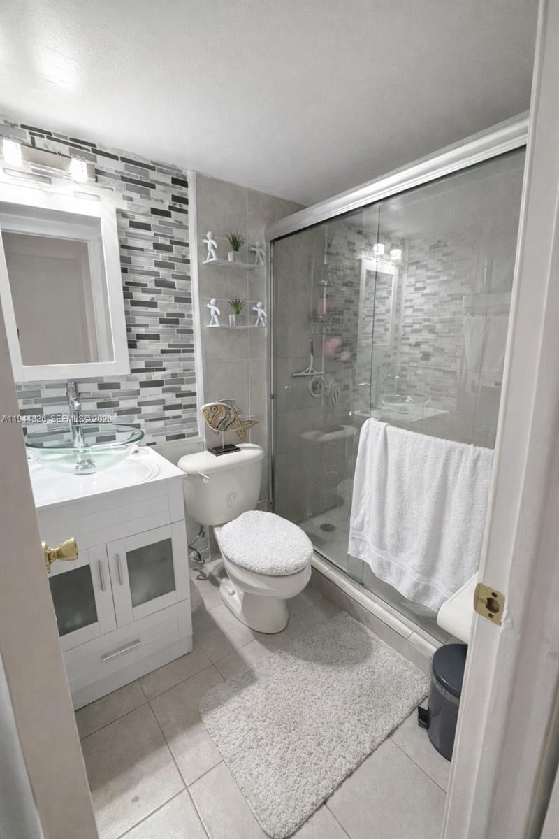 8460 Southwest 154th Cir Court, Unit 121 Miami, FL 33193 - Photo 6 of 9 a bathroom with a toilet sink and shower