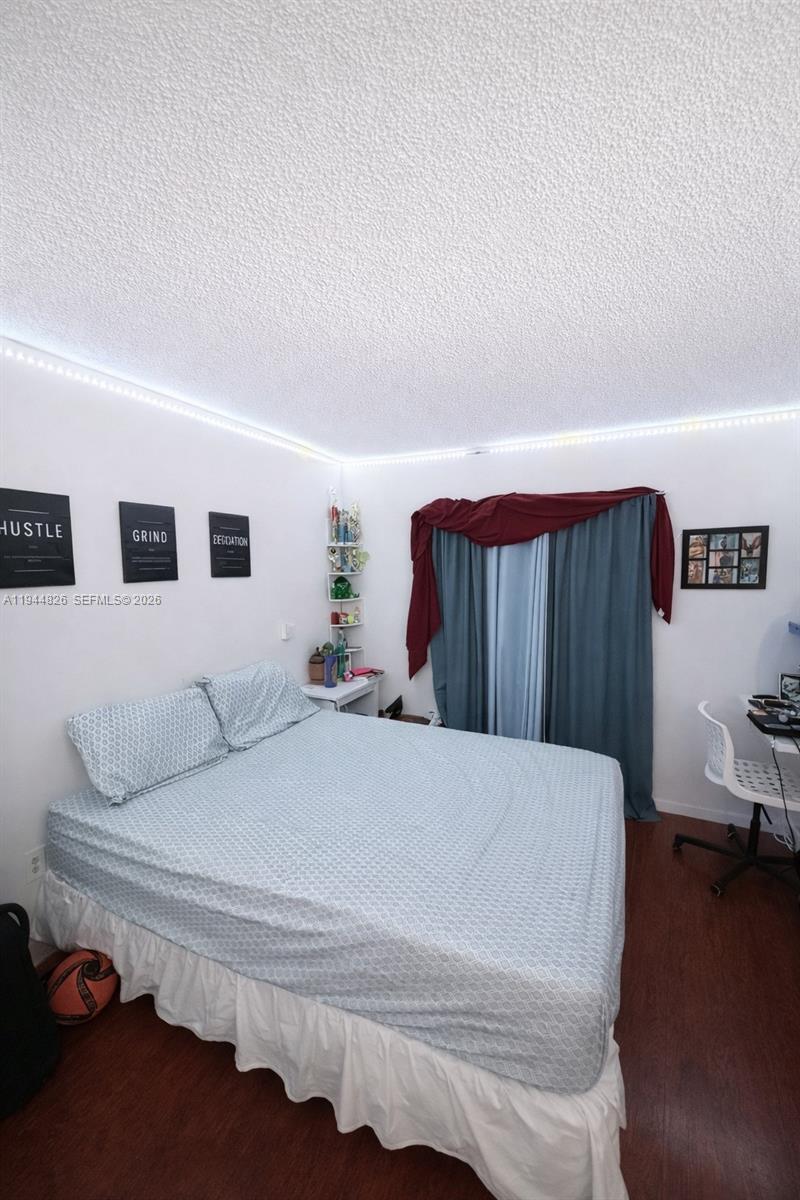8460 Southwest 154th Cir Court, Unit 121 Miami, FL 33193 - Photo 7 of 9 a bedroom with a bed and a couch