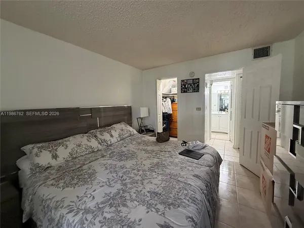 a bedroom with a bed and cabinets