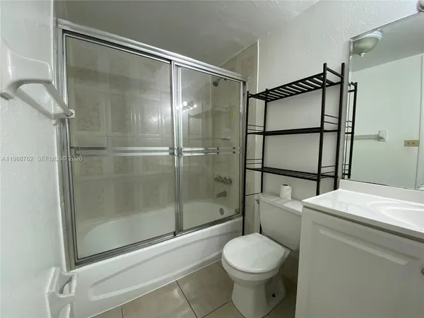 a bathroom with a shower and a toilet
