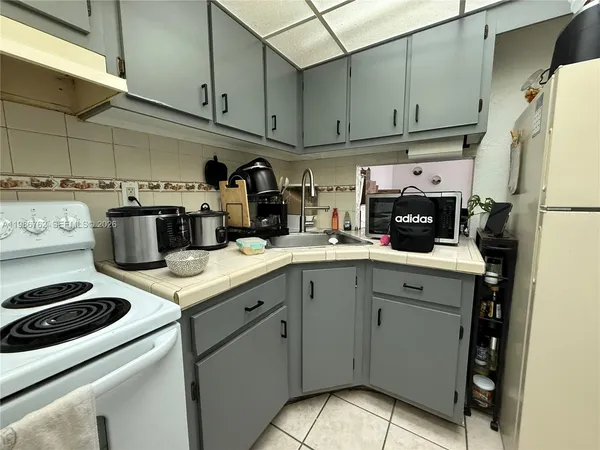 a kitchen with a sink cabinets and appliances