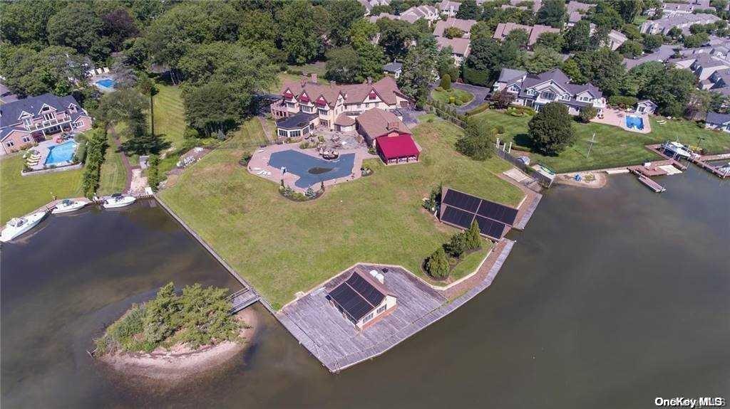 an aerial view of a house with swimming pool outdoor seating and yard