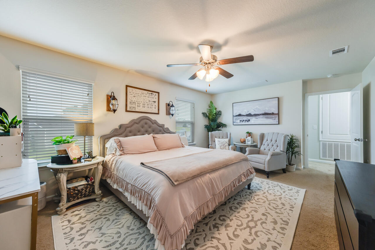 4648 Plover Drive Crestview, FL 32539 - Photo 20 of 71 a bedroom with a bed a couch and potted plant with the dresser
