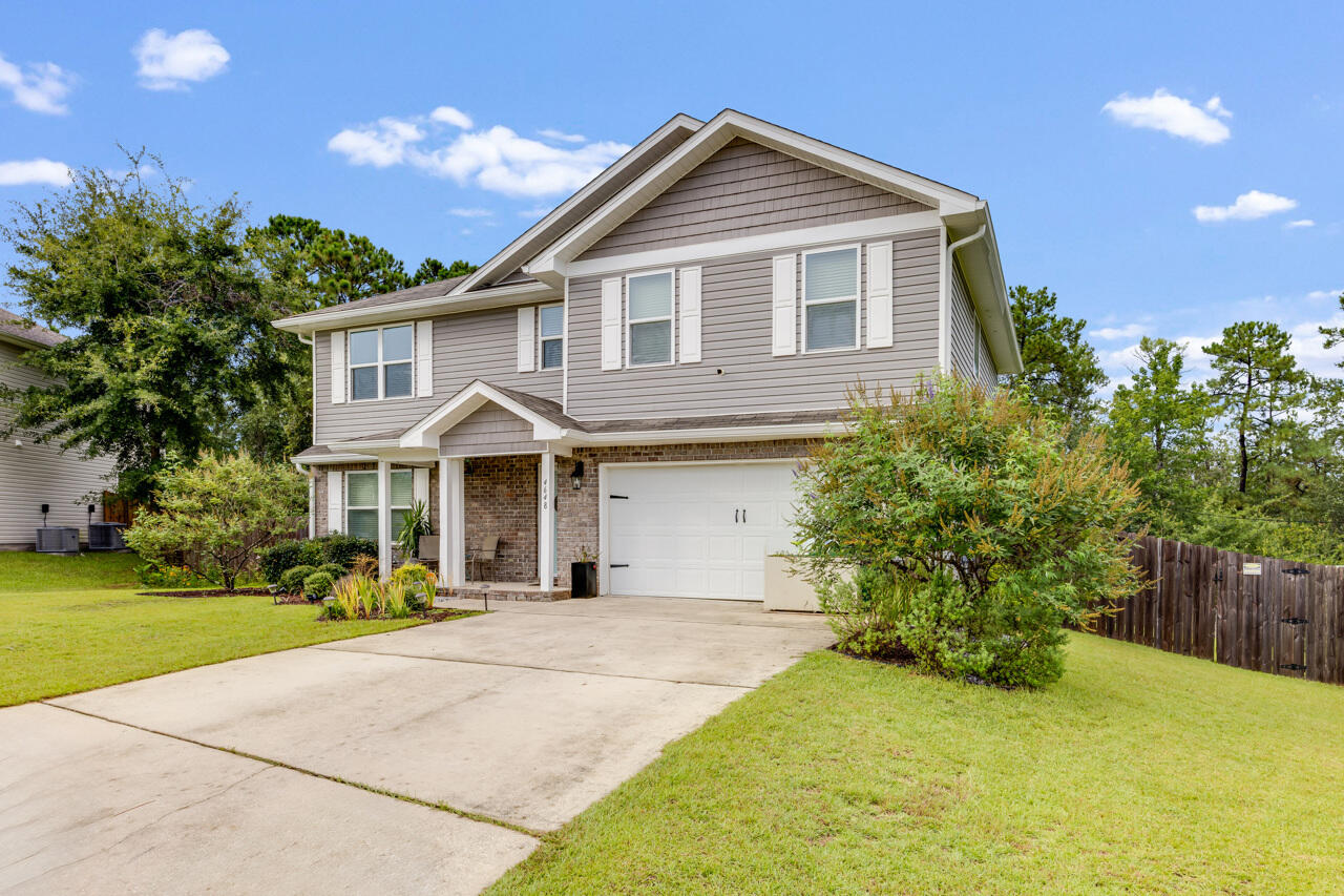 4648 Plover Drive Crestview, FL 32539 - Photo 53 of 71 a front view of a house with a garden
