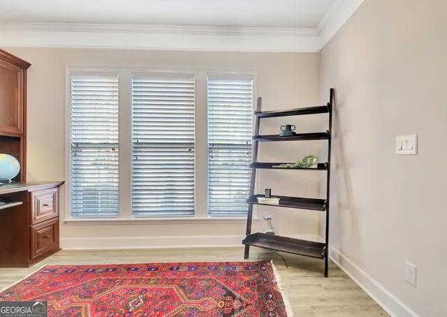 a dining room with furniture and wooden floor