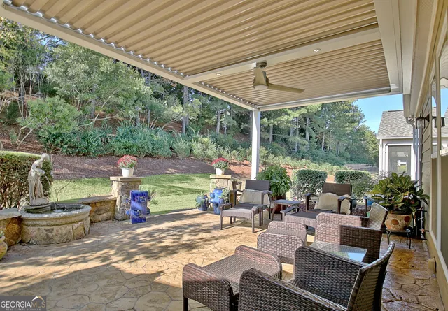 a front view of a house with a garden and trees