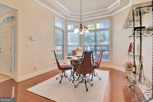 a living room with furniture a chandelier and a fireplace