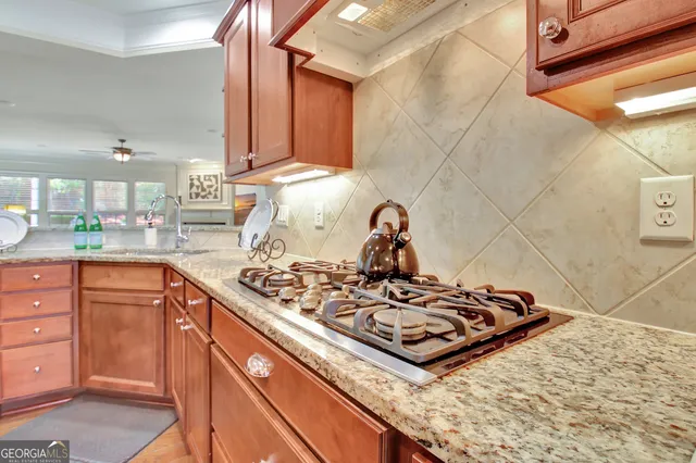 a bathroom with a granite countertop tub a sink and a large mirror