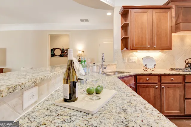 a view of a house with a big yard and large tree