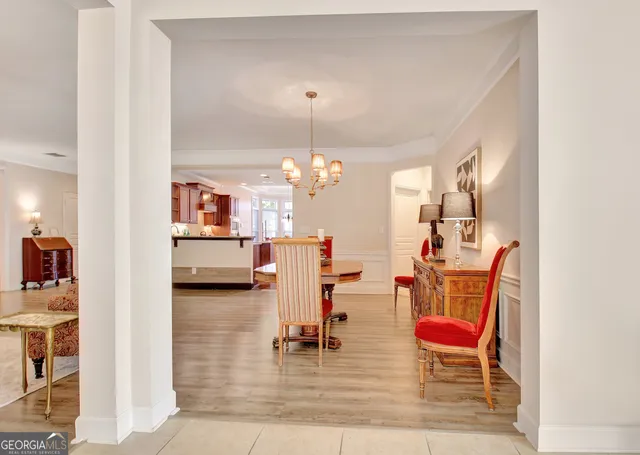 a outdoor space with lots of tables a large window and chairs