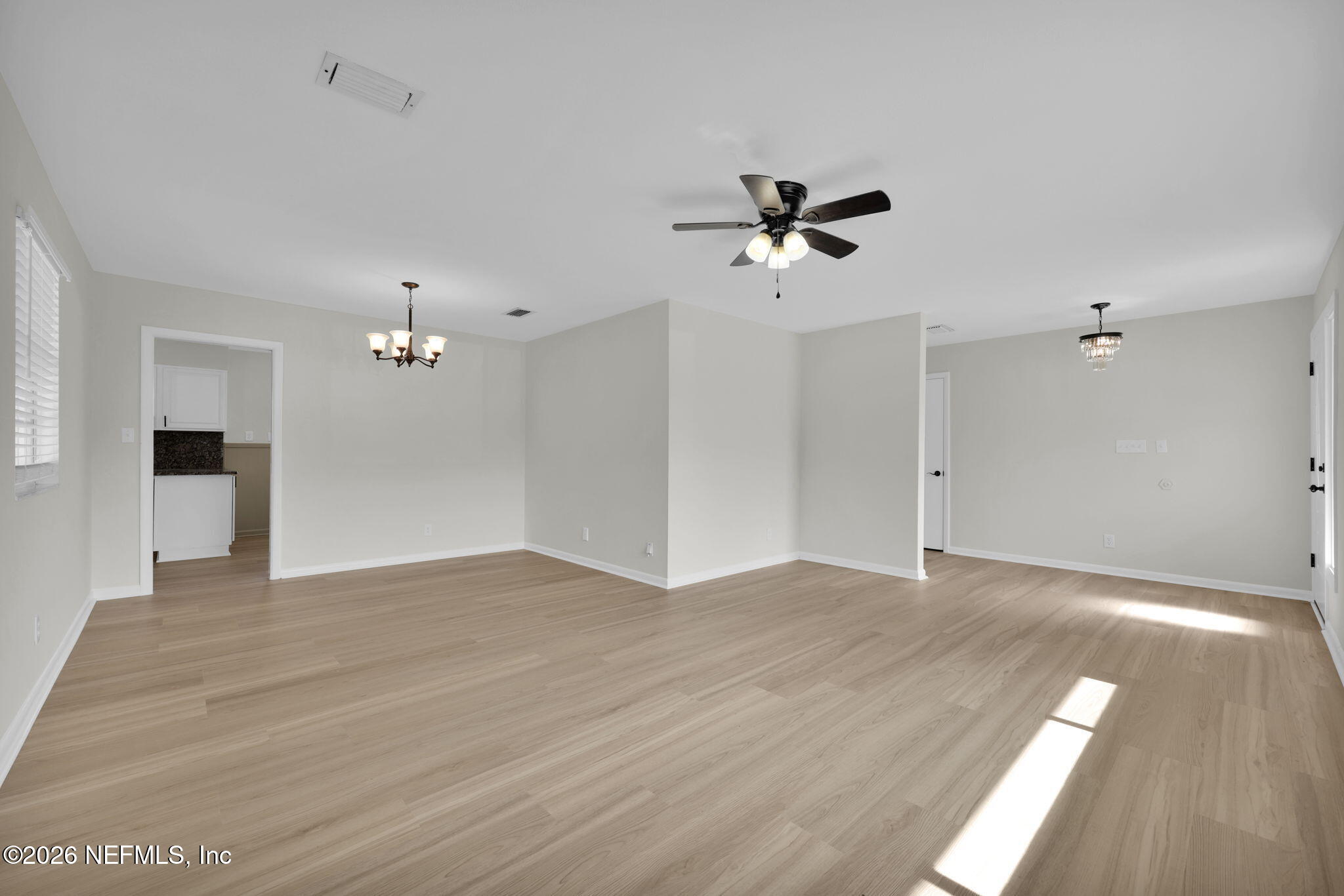 8544 Sanchez Road Jacksonville, FL 32217 - Photo 11 of 46 a view of a room with wooden floor and ceiling fan