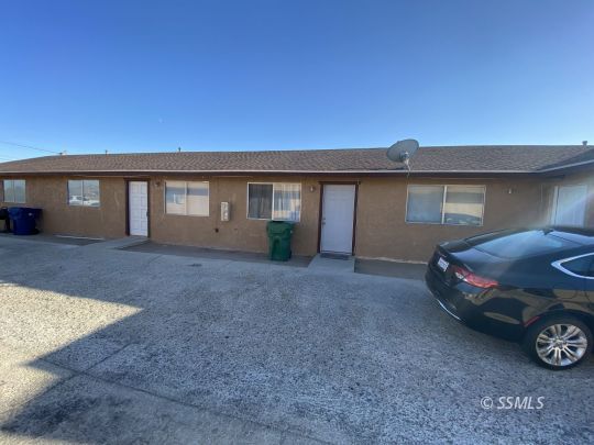 201 South Sunset Street Ridgecrest, CA 93555 - Photo 3 of 20 a front view of a house with a garden