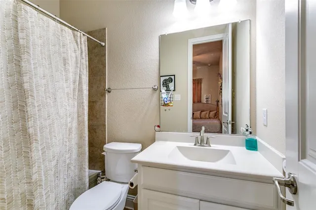 a bathroom with a sink toilet and mirror