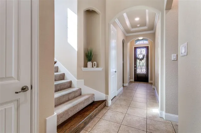 a view of a hallway with wooden floor and entryway