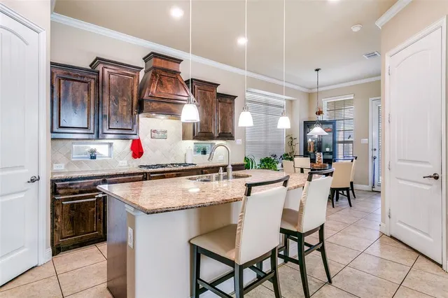 a kitchen with granite countertop a sink cabinets and stainless steel appliances