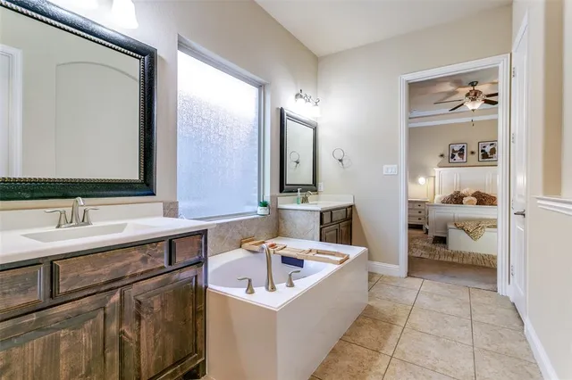 a bathroom with a sink a mirror and a bathtub
