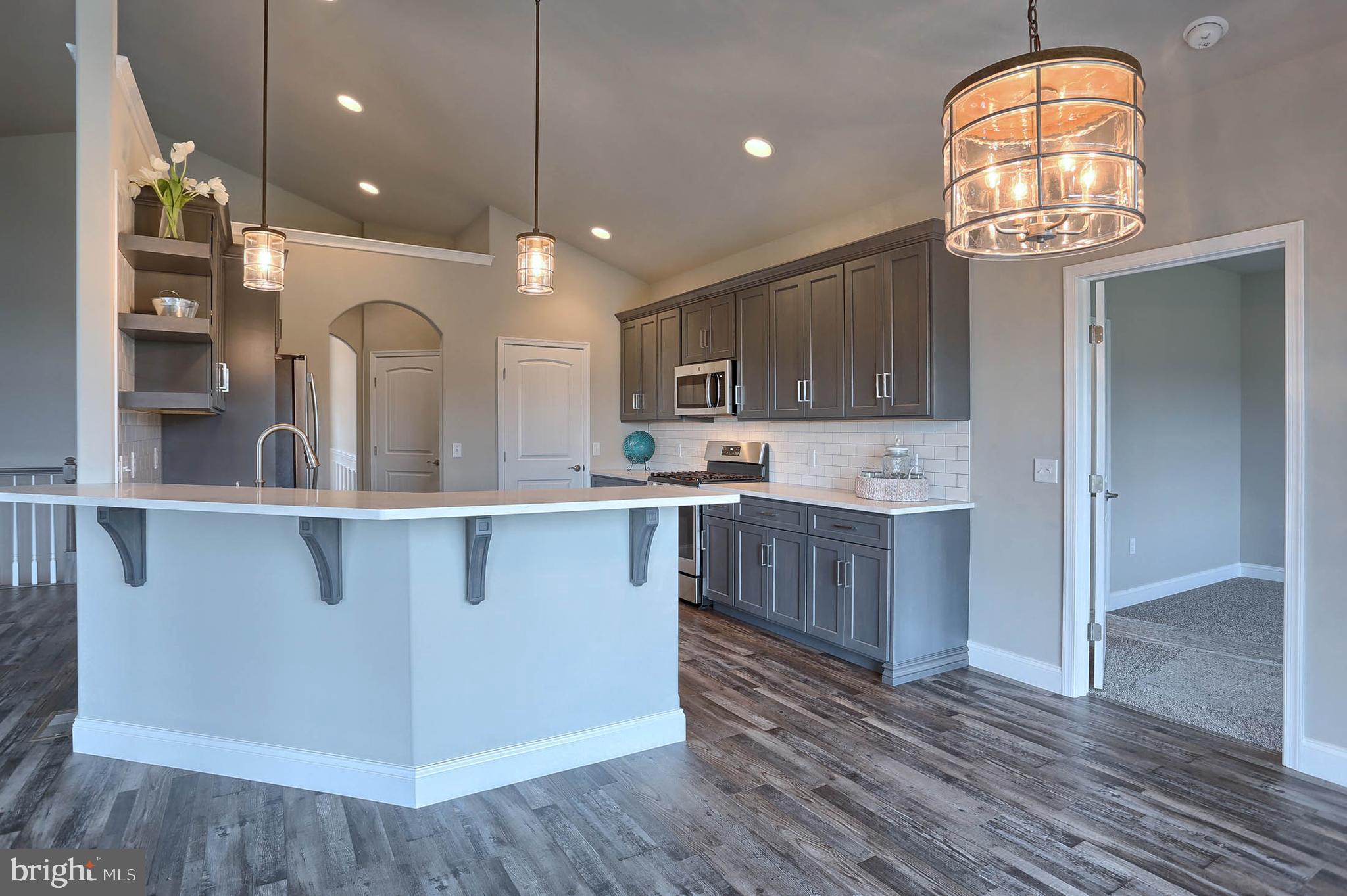 21 Rolling Meadow Road Lebanon, PA 17046 - Photo 15 of 37 a open kitchen with cabinets a stove and a wooden floor