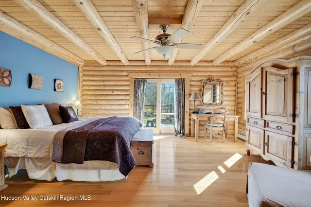 a spacious bedroom with two beds and a window