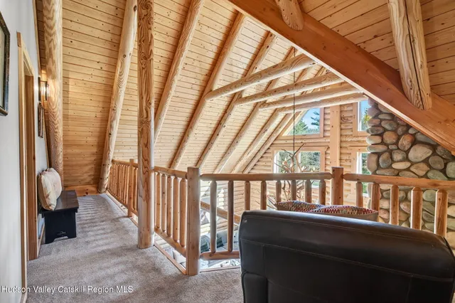 a living room with furniture a flat screen tv and a large window