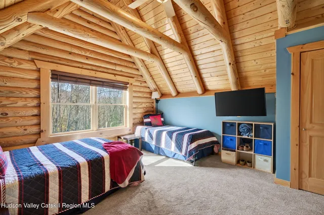 a living room with furniture a flat screen tv and a large window