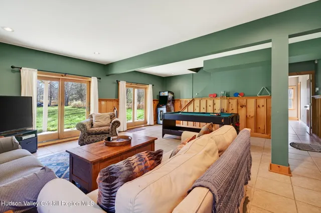 a view of a patio with table and chairs with plants and wooden fence