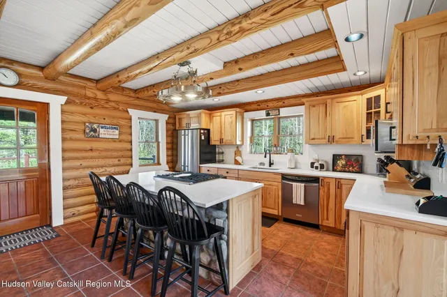 a large kitchen with a table and chairs in it