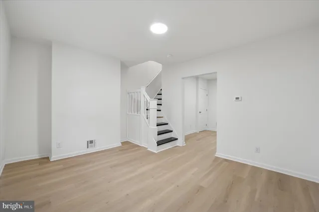 a view of a room with wooden floor and window