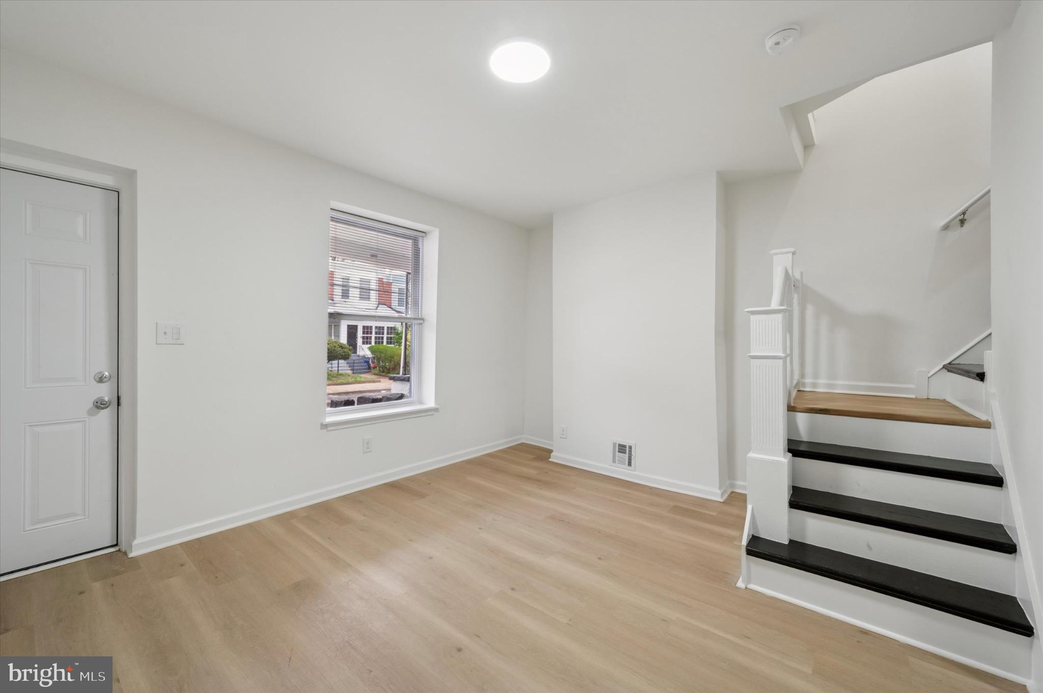 1452 North 56th Street Philadelphia, PA 19131 - Photo 3 of 12 wooden floor in an empty room with a window