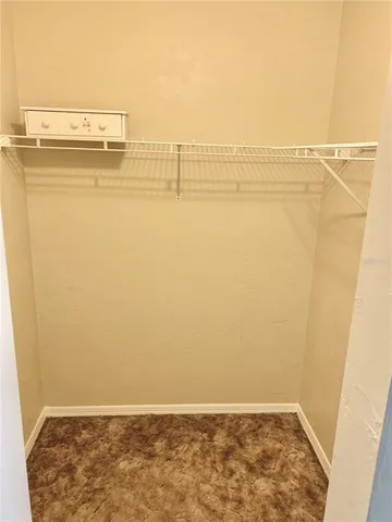 a view of water heater room with wooden floor