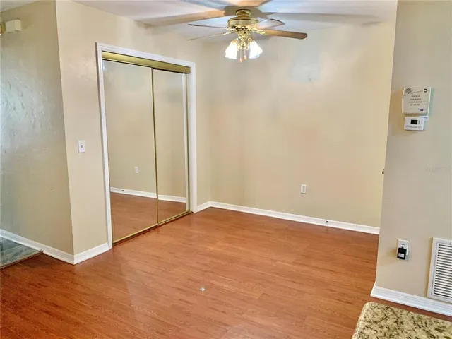 a view of an empty room with wooden floor
