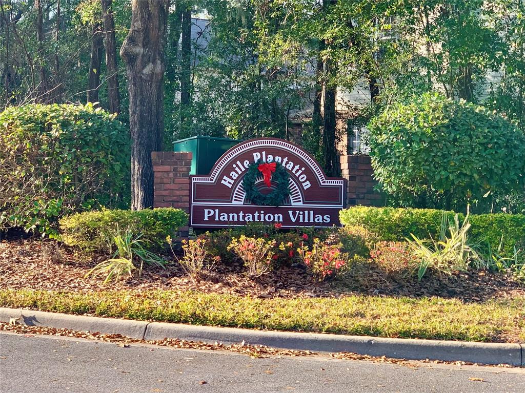 5268 Southwest 97 Way Gainesville, FL 32608 - Photo 32 of 33 a view of a street sign under a large tree