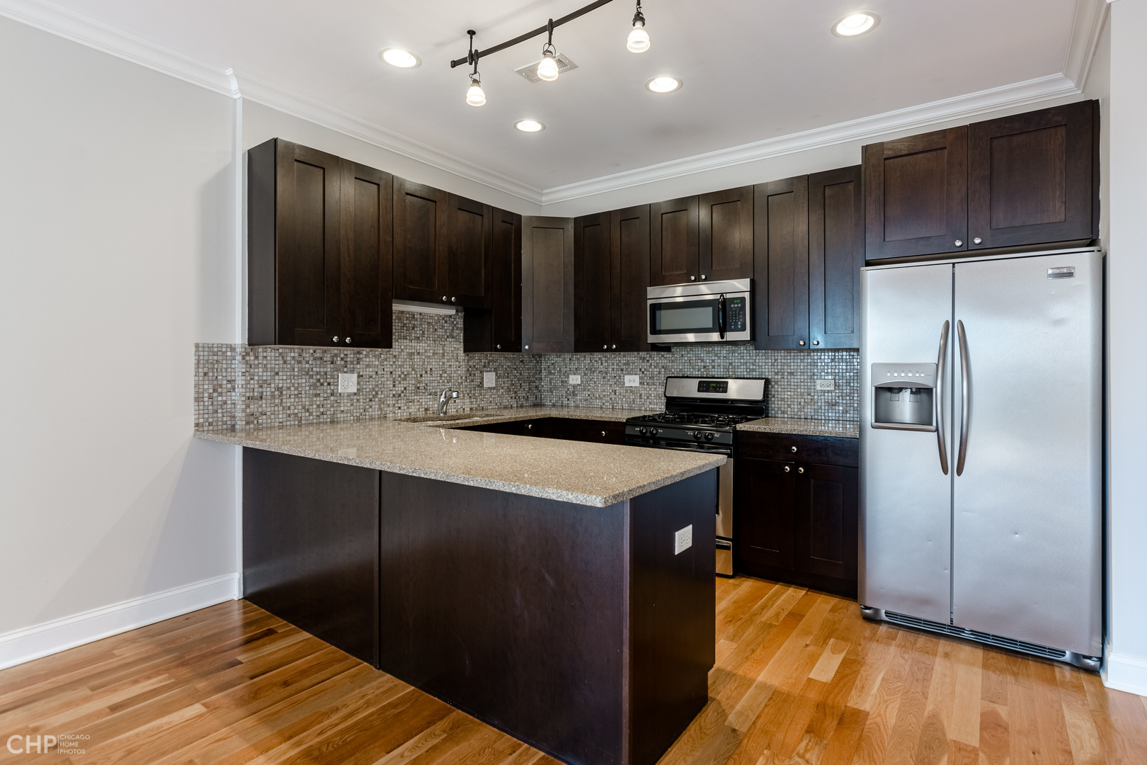 17 North Bishop Street, Unit 3 Chicago, IL 60607 - Photo 2 of 9 a kitchen with stainless steel appliances granite countertop a refrigerator a stove and a sink