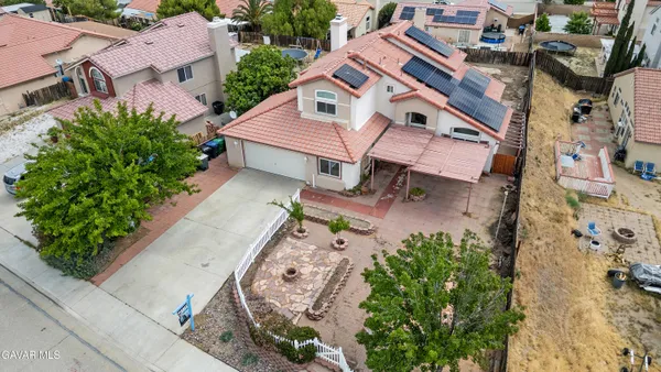 an aerial view of a house with a yard