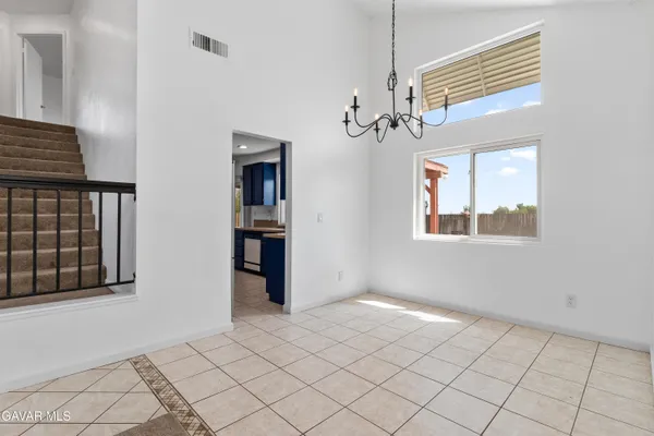an empty room with windows and fireplace