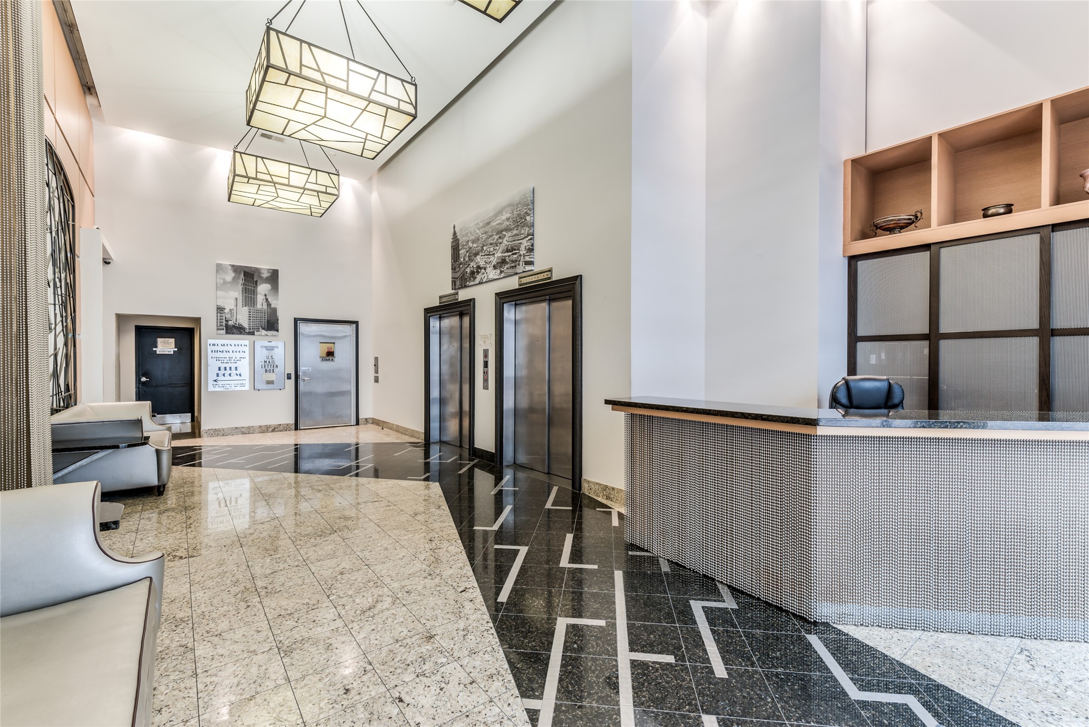 705 Main Street, Unit 215 Houston, TX 77002 - Photo 32 of 36 Well-lit lobby featuring sleek granite flooring, contemporary lighting fixtures, and a stylish concierge desk.