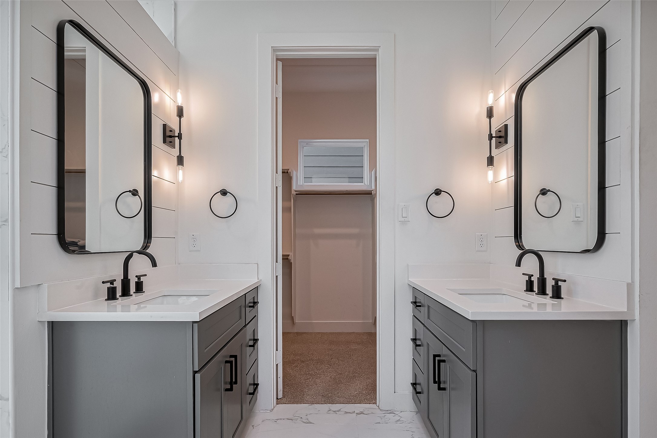 2518 Terry Street Houston, TX 77009 - Photo 13 of 17 Modern ensuite bathroom featuring dual vanities, designer lighting, matte black fixtures, and direct access to the walk-in closet.