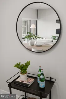 a bathroom with a granite countertop toilet a sink and a mirror