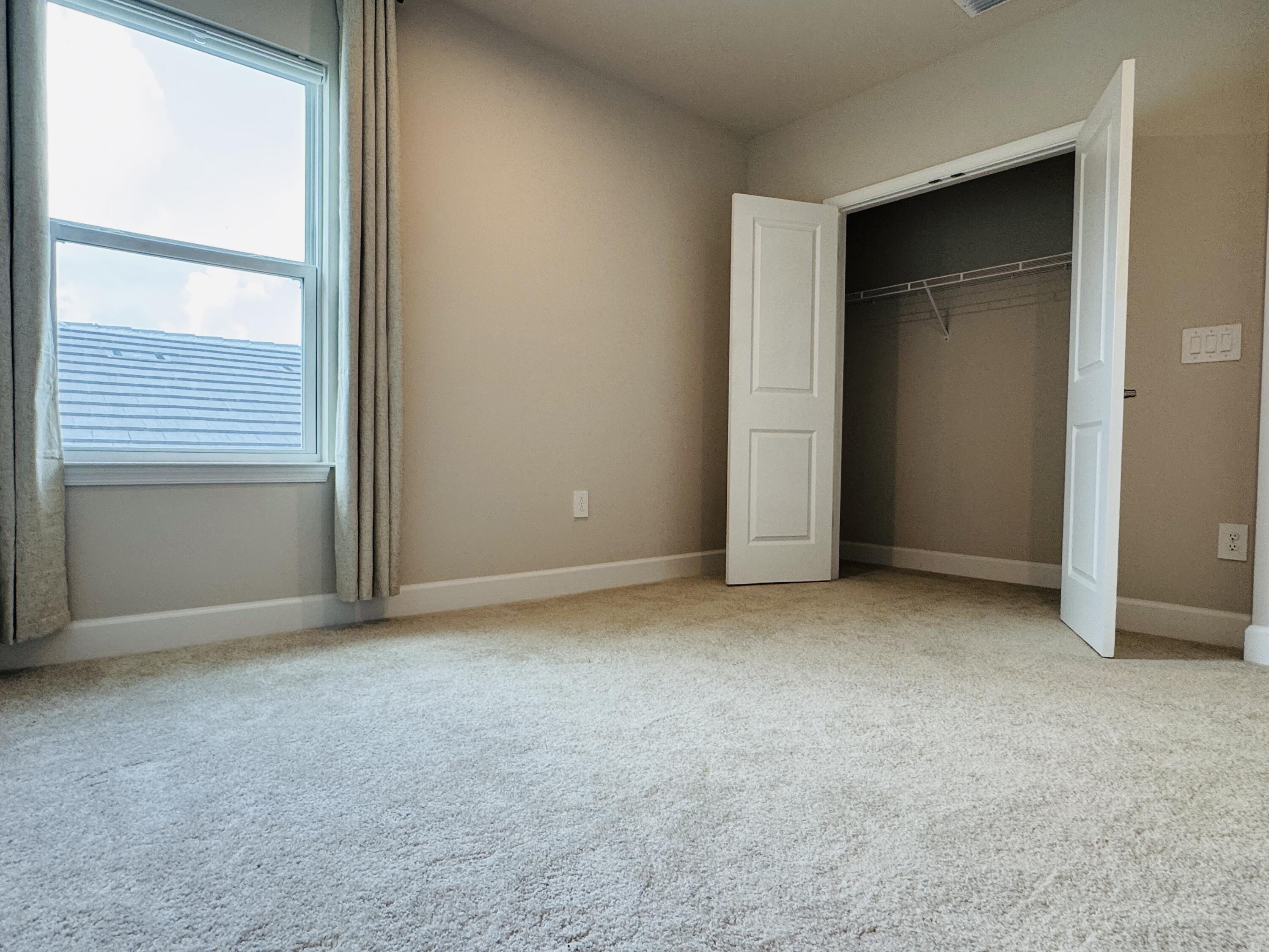 163 Southwest Pomeroy Street Stuart, FL 34997 - Photo 43 of 52 an empty room with windows and closet