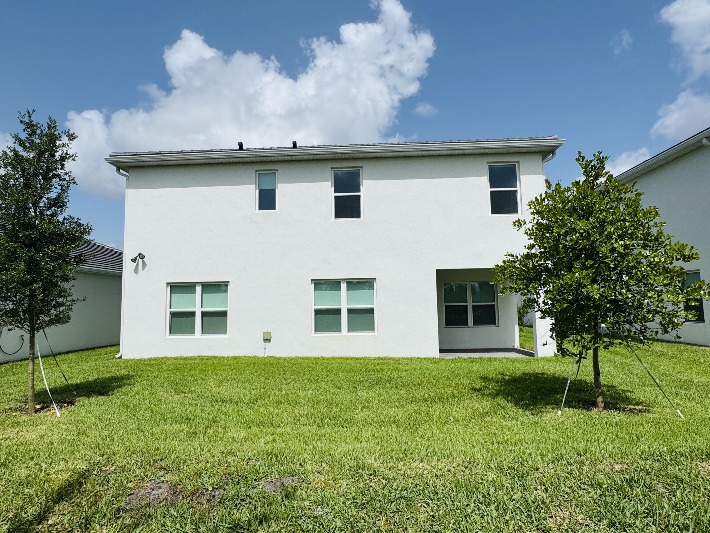 163 Southwest Pomeroy Street Stuart, FL 34997 - Photo 50 of 52 a view of a house with a yard