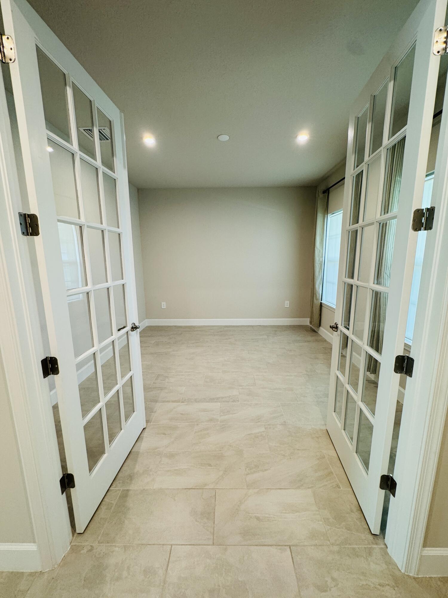 163 Southwest Pomeroy Street Stuart, FL 34997 - Photo 9 of 52 a view of an empty room with a window