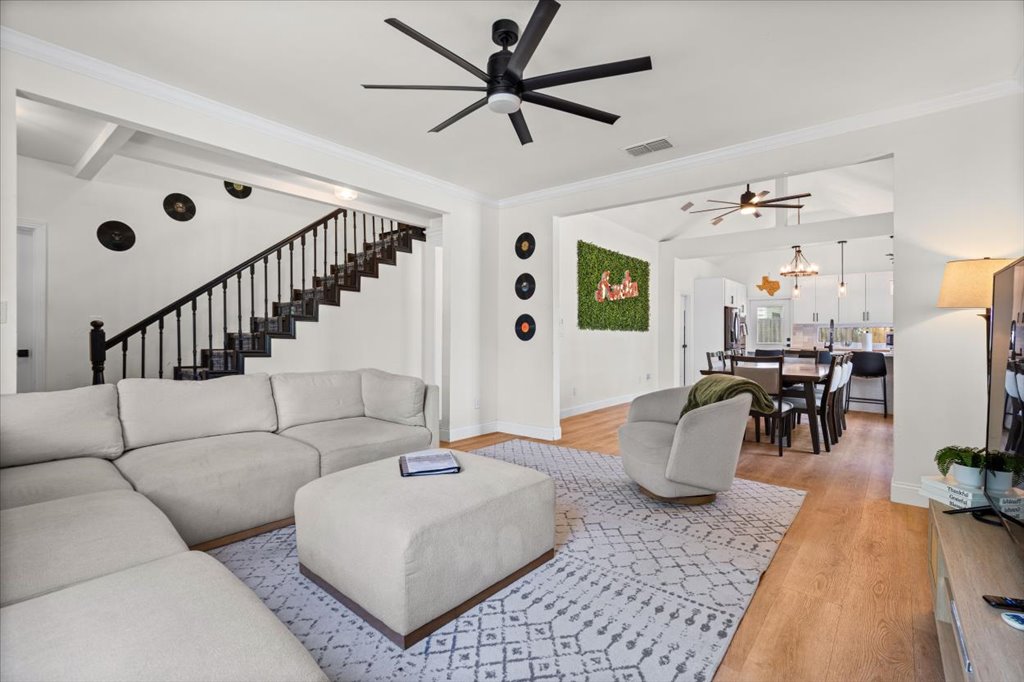 1201 Garden Street, Unit A Austin, TX 78702 - Photo 3 of 30 Open-concept living area with wood-finish flooring, white crown molding, and a black ceiling fan