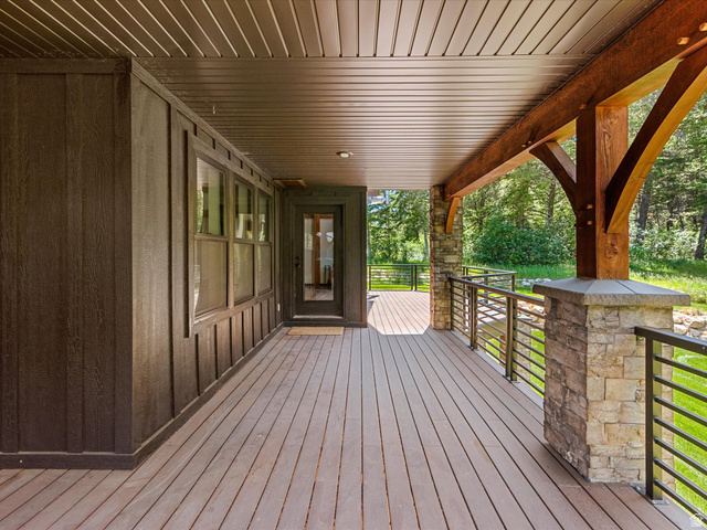1225 Old Oregon Road Soda Springs, ID 83276 - Photo 44 of 67 Expansive outdoor deck featuring wood-finish flooring, stone pillars, and horizontal metal railings