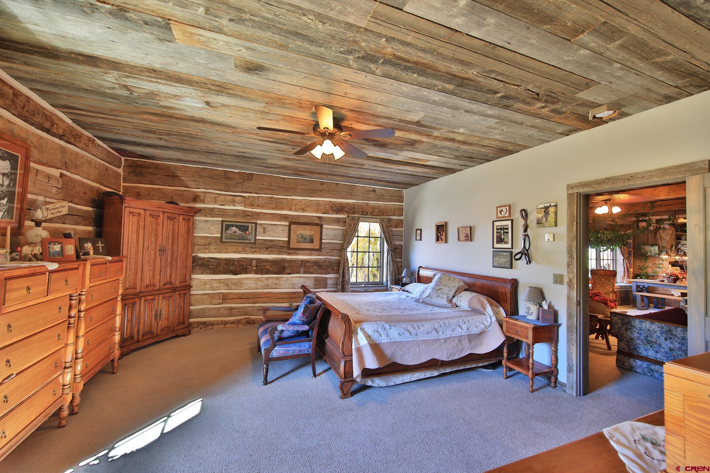 10497 54 7/10 Road Molina, CO 81646 - Photo 14 of 45 a bedroom with a bed and a walk in closet