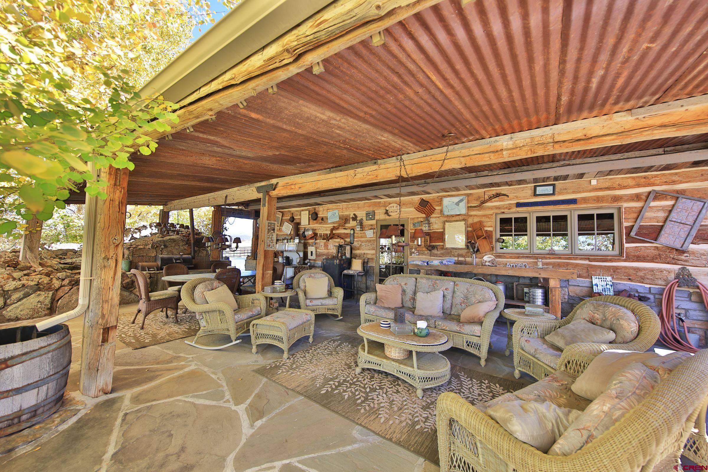 10497 54 7/10 Road Molina, CO 81646 - Photo 24 of 45 a roof deck view with table and chairs and potted plants