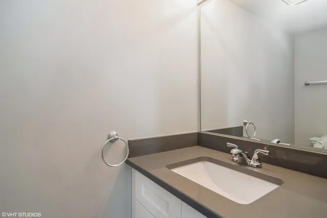 a bathroom with a sink vanity and a mirror